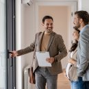 A young couple with a real-estate agent visiting an apartment fo